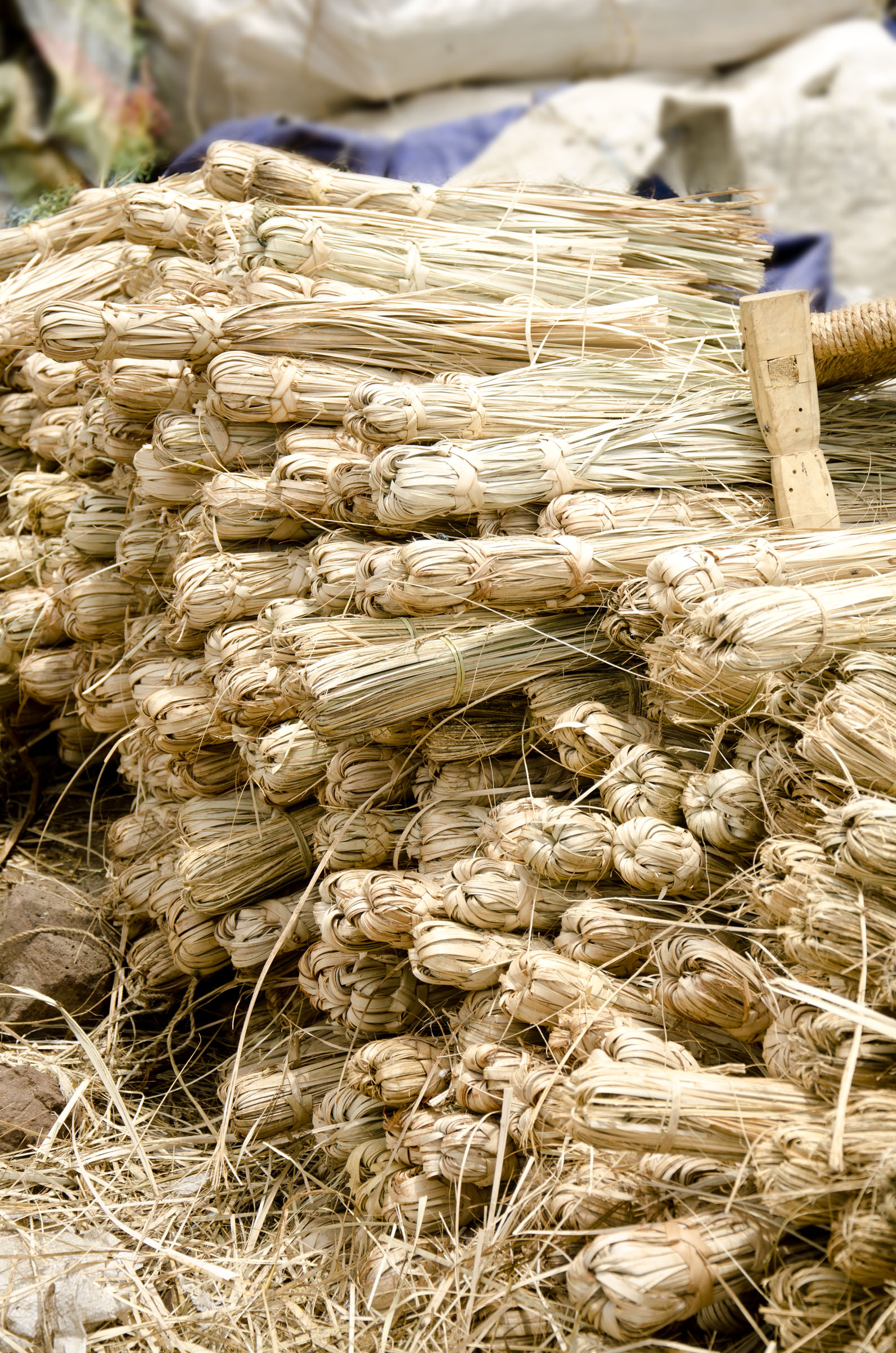 Stacked brooms on Ethiopian market stall