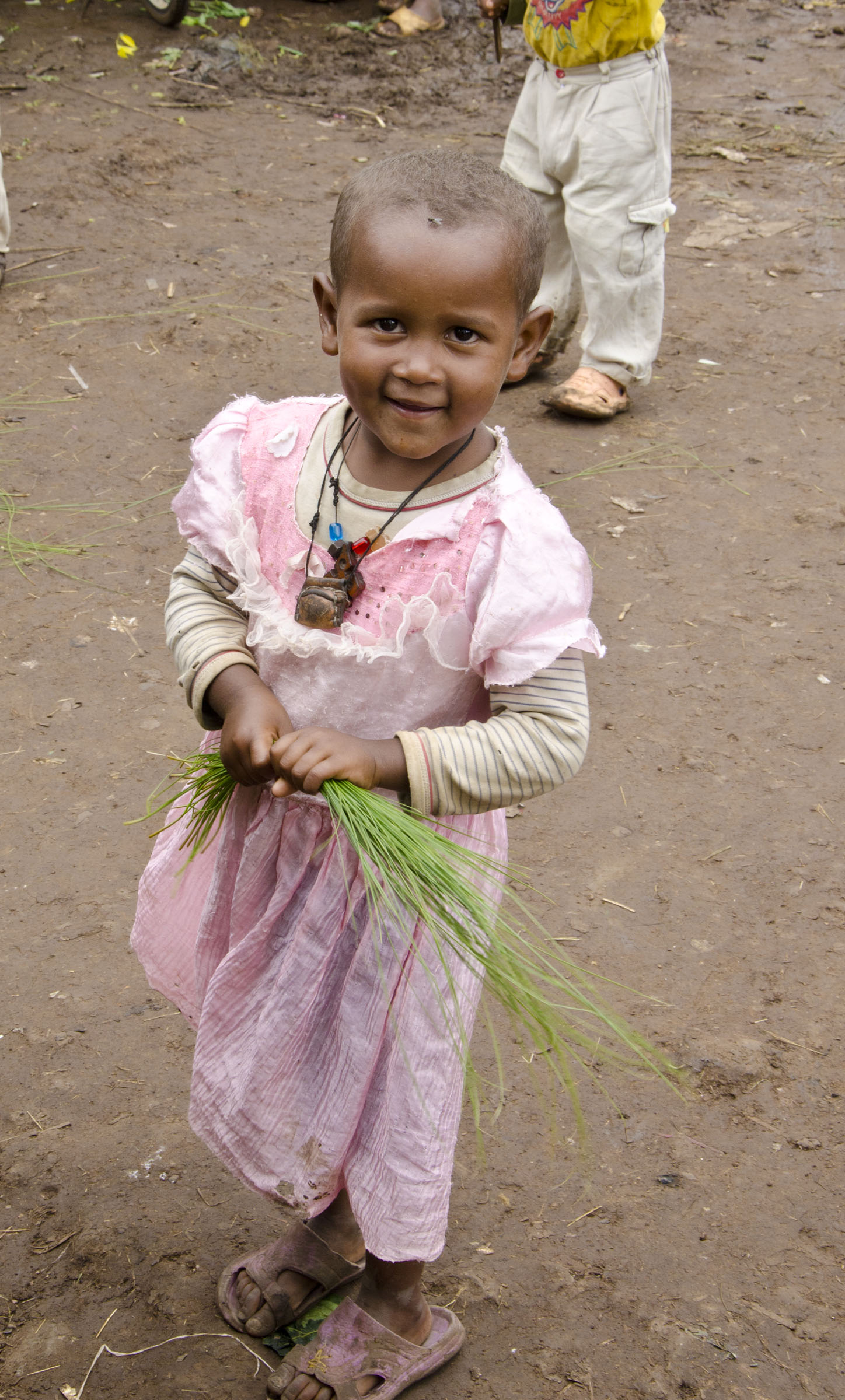 Young Ethiopian girl clutching papyrus leaves